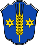 Wappen Gemeinde Berumbur In diesem Bild sehen Sie das Wappen der Gemeinde Berumbur. Der Hintergrund ist blau. Auf dem Wappen befindet sich rechts und links jeweils ein Stern und in der Mitte eine Gerstenpflanze.